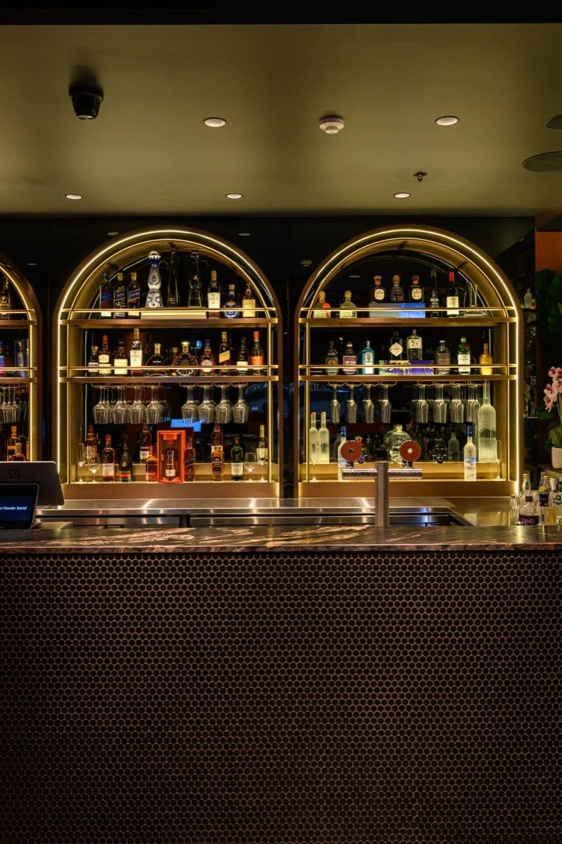 The backlit spirits display behind the bar at Gunpowder Social
