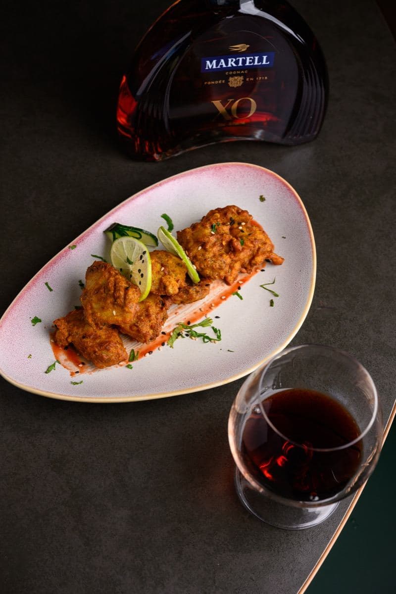 Cognac poured beside a plate at Gunpowder Social