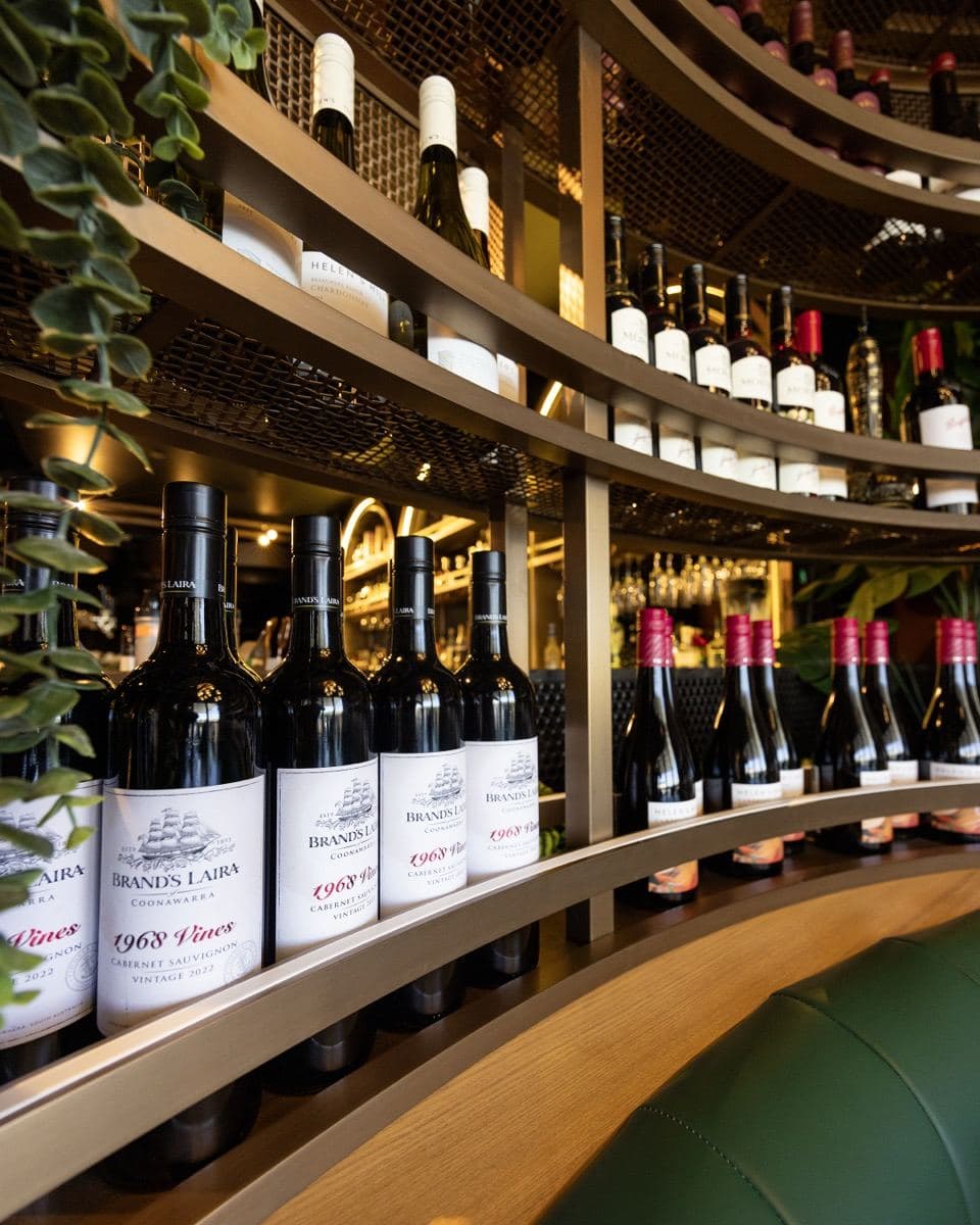 Red wine bottles on the wine wall at Gunpowder Social