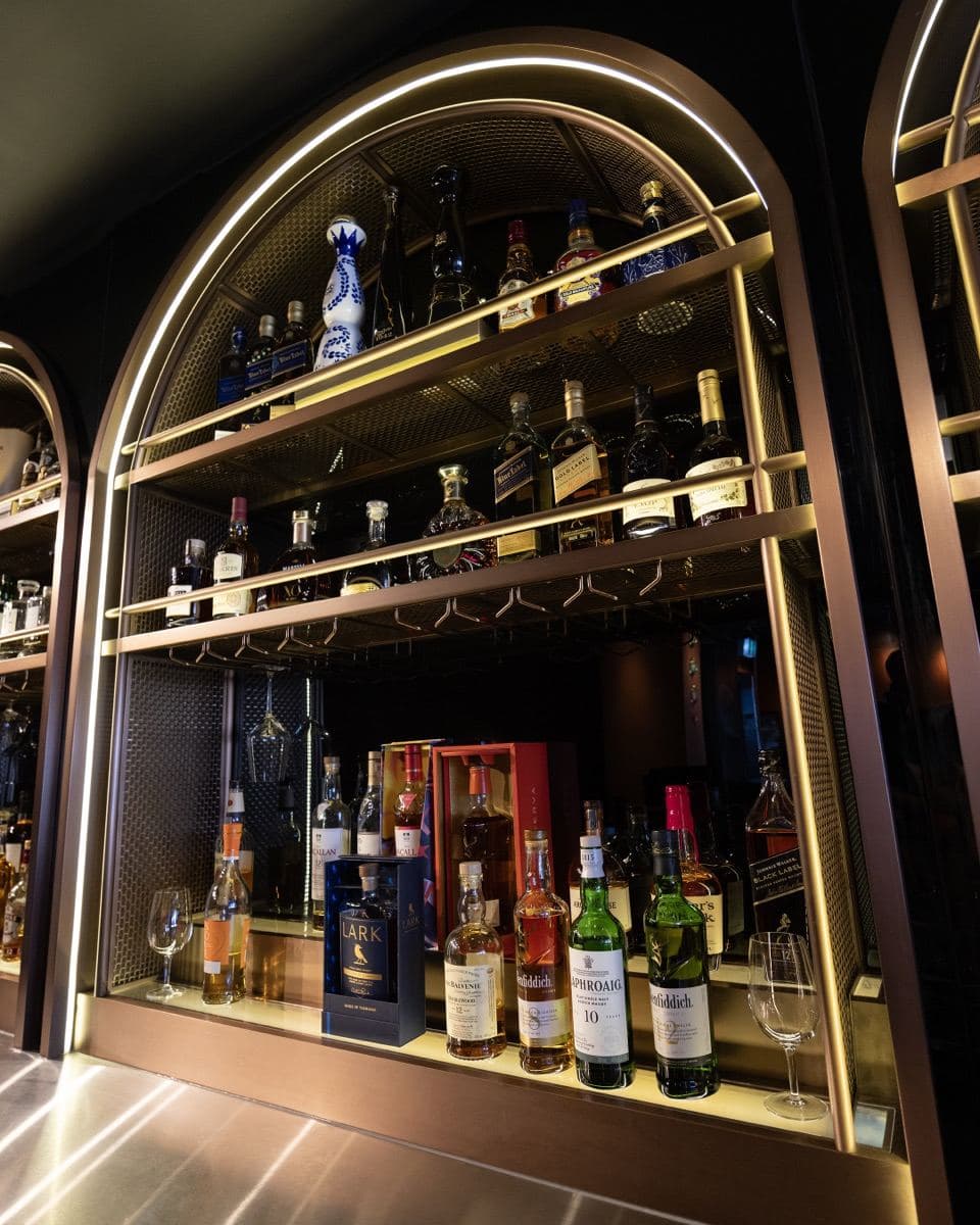 Single malts on the lit bar shelf at Gunpowder Social